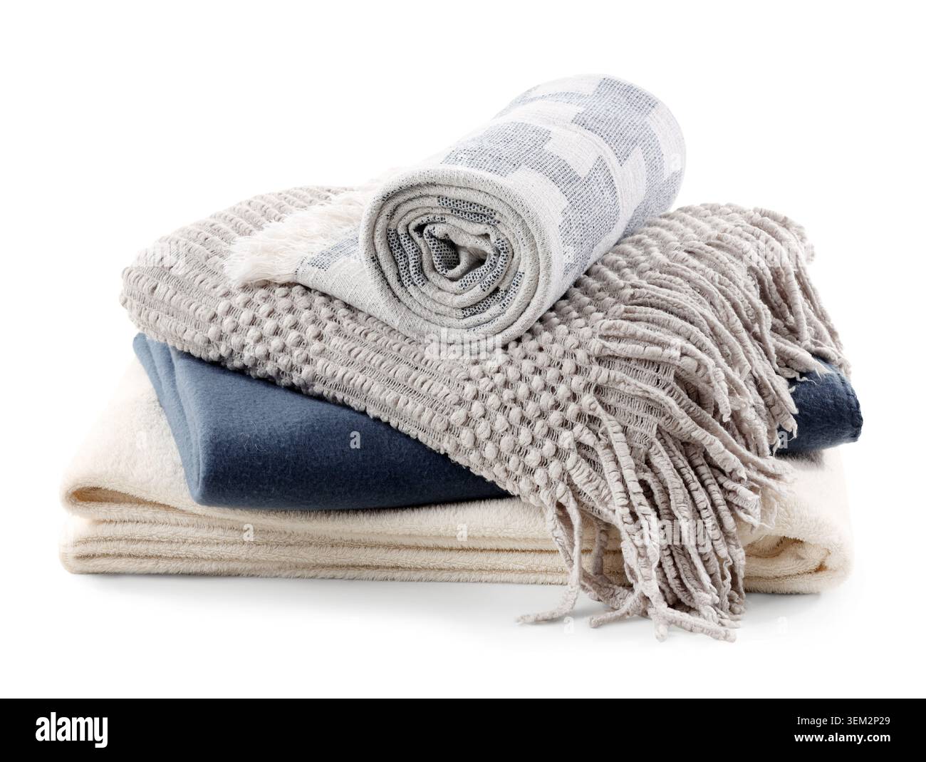 Stack of different soft blankets isolated on white background Stock Photo