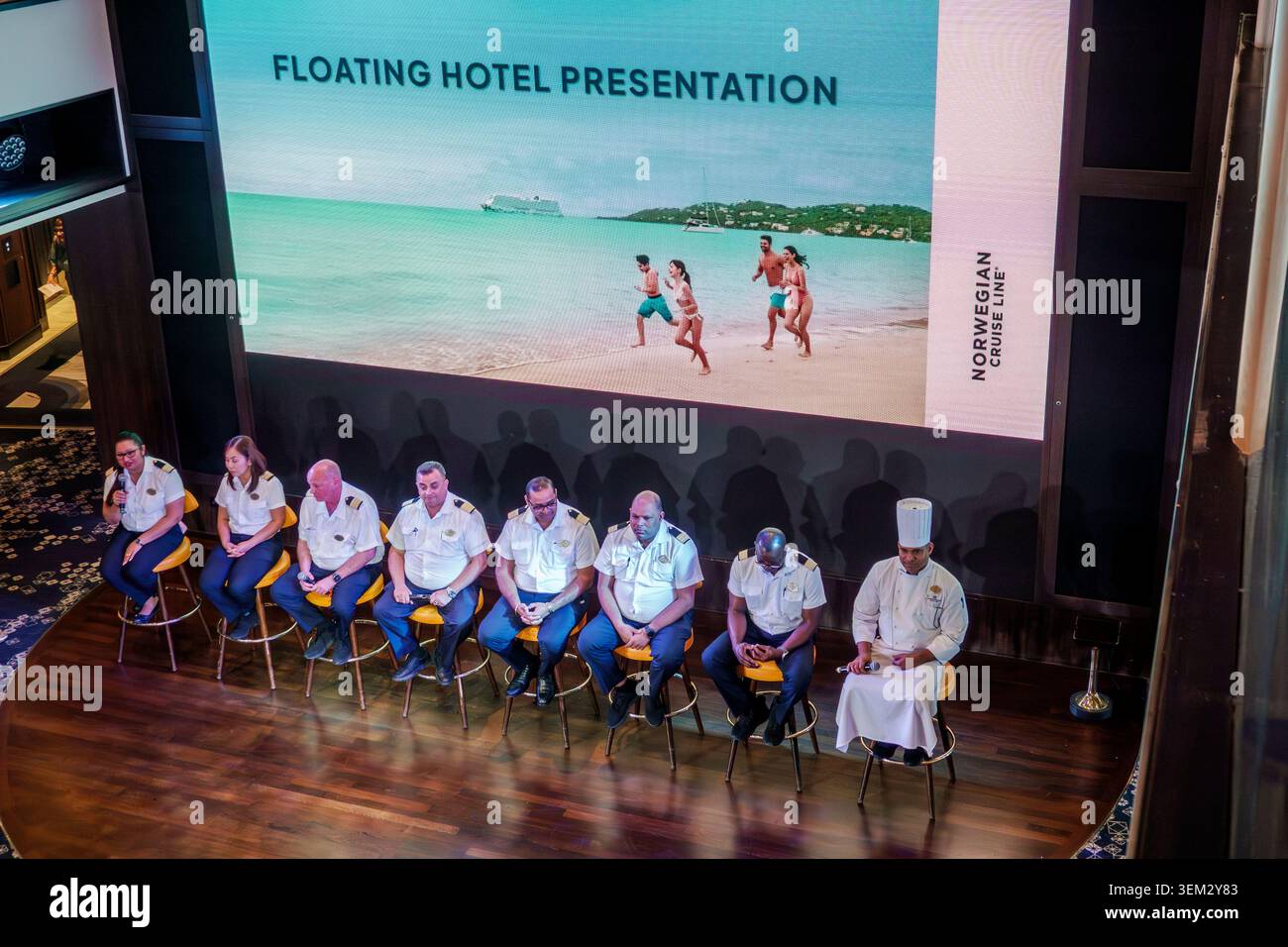 Atlantic Ocean,crew presentation,ship officers,staff event,onboard presentation,public gathering,stage,event venue,crew members,uniformed staff,hospit Stock Photo