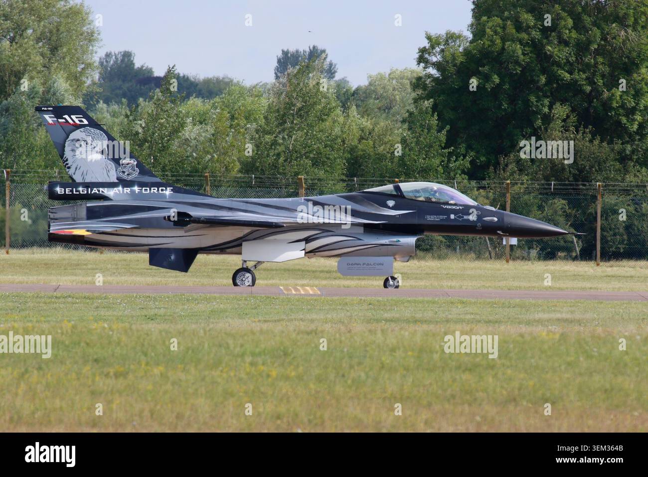 A Belgian Air Force General Dynamics F-16AM Fighting Falcon (registration FA-57) commemorative D-Day livery climbs into the sky during an airshow Stock Photo