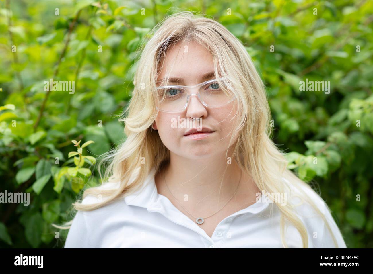 Scientist female with blonde hair outside in a green area Stock Photo