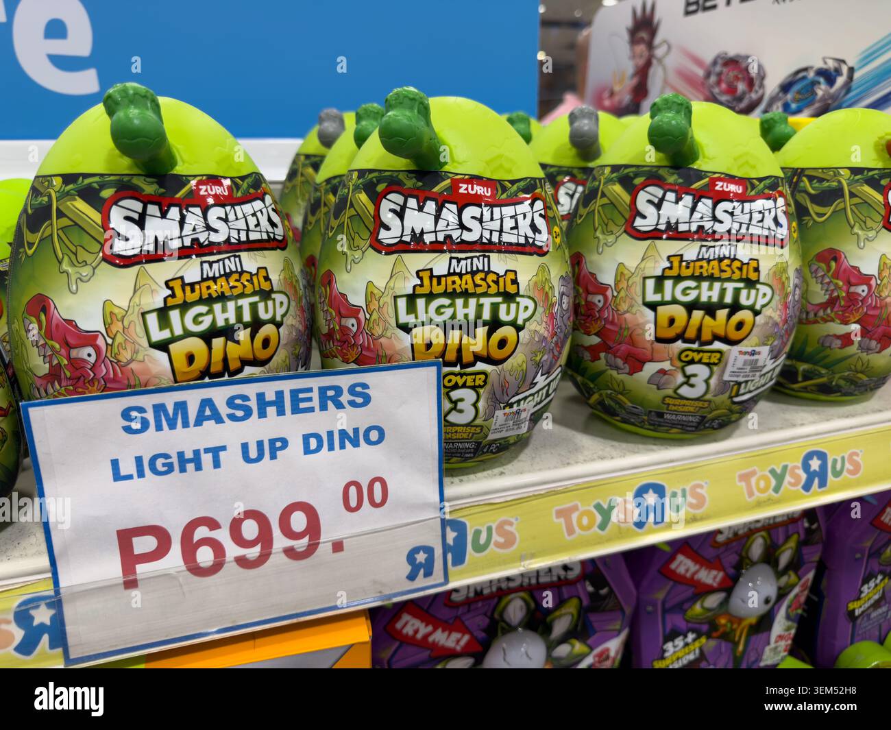 Smashers Mini Jurassic Light Up Dino toys displayed with price signage on sale at Toys R Us store in Cebu City, Philippines. - Smartphone Captured Stock Image