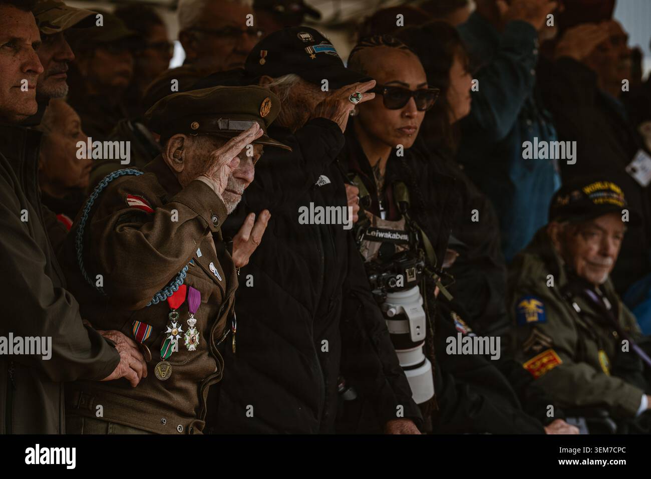 A World War II veteran salutes during the playing of the national ...