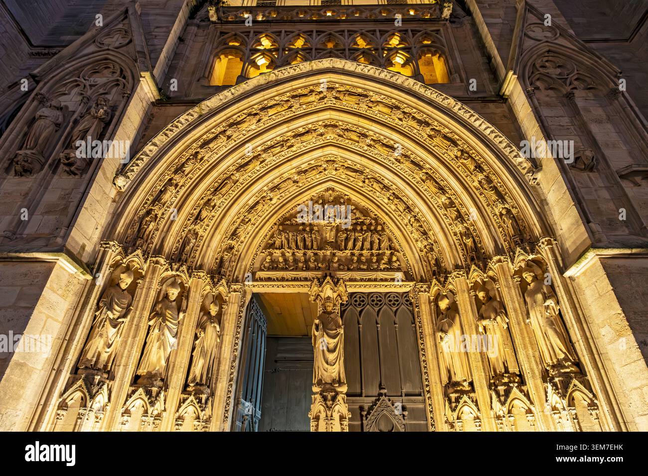 A close-up view of the illuminated Gothic portal, showcasing its complex sculpture and arches, Bordeaux, France Stock Photo
