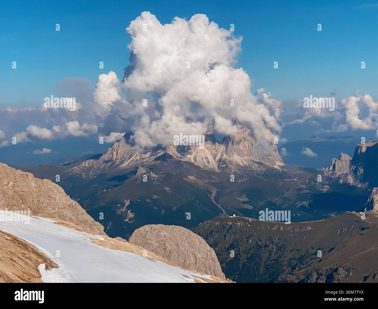 Mountain ridge and dramatic cumulus cloud over alpine valley Stock Photo