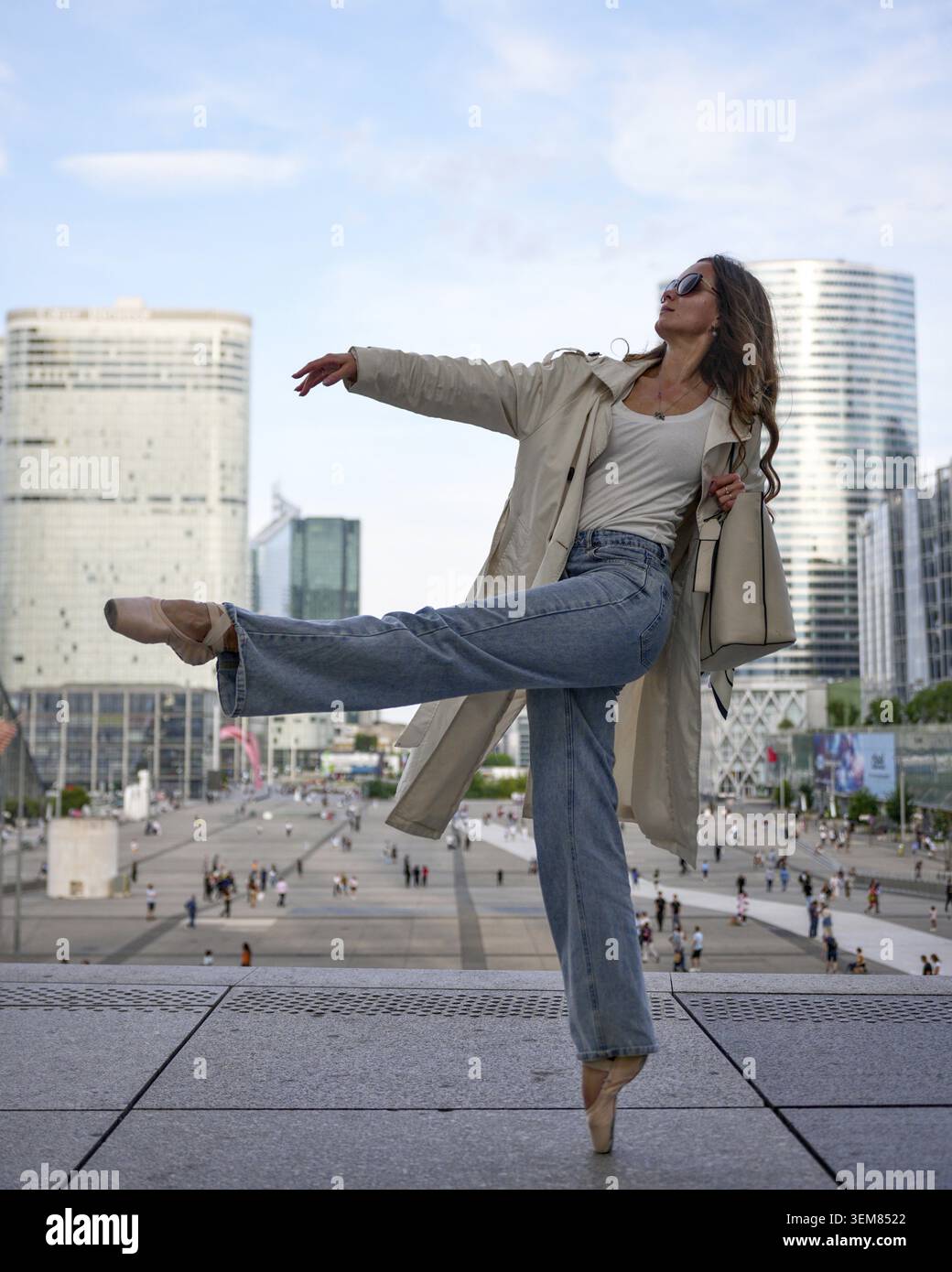 Modern ballerina performing elegant dance pose outdoors Stock Photo