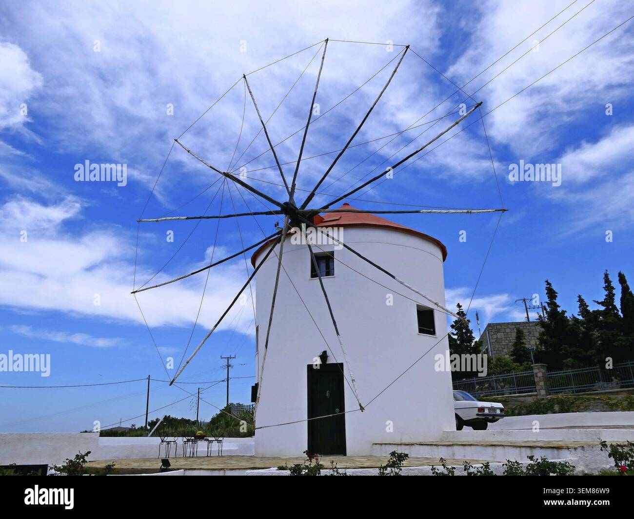 Ancient windmill features a white cylindrical structure with a red ...