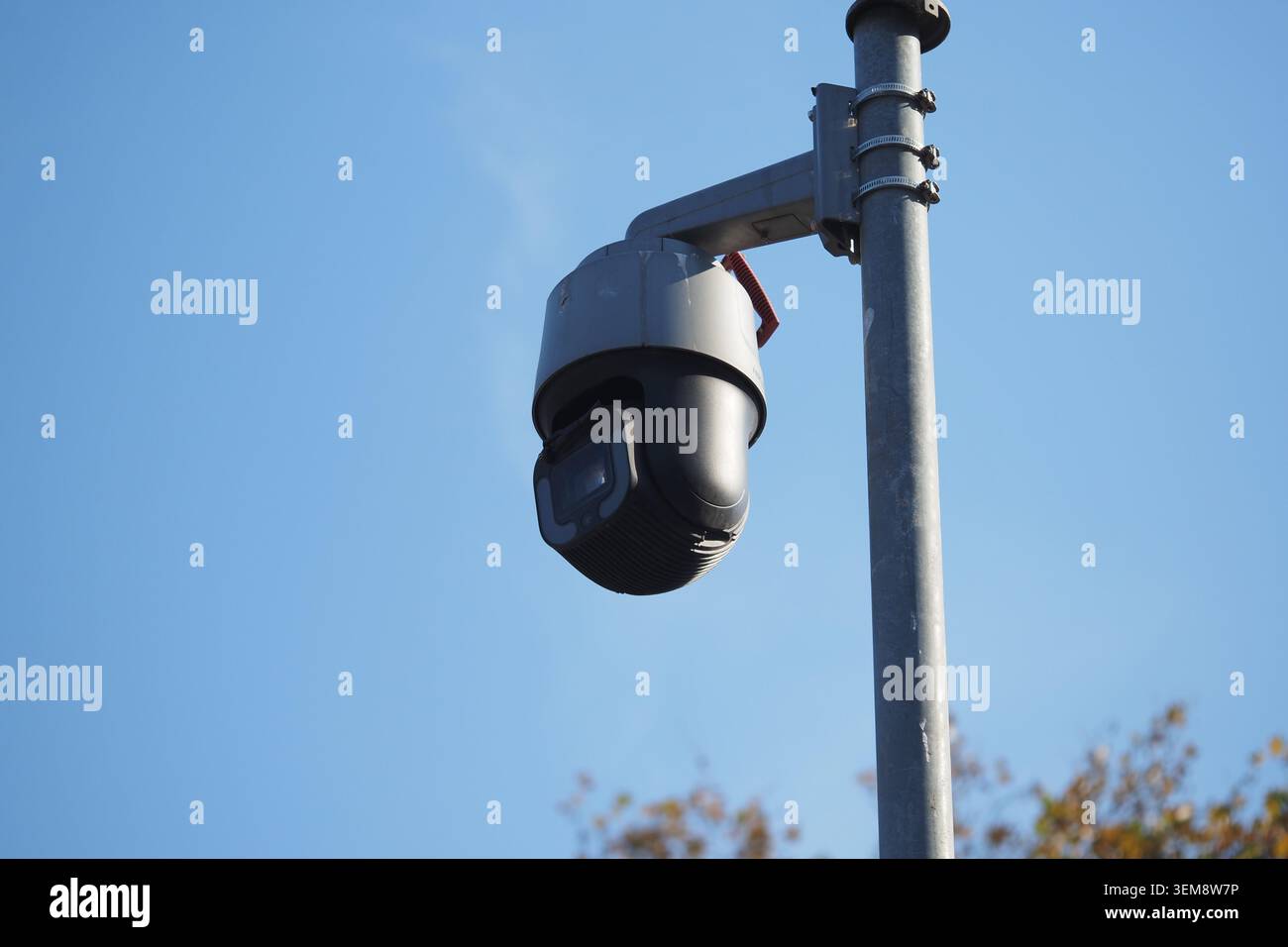 Security camera mounted on pole during daylight hours Stock Photo