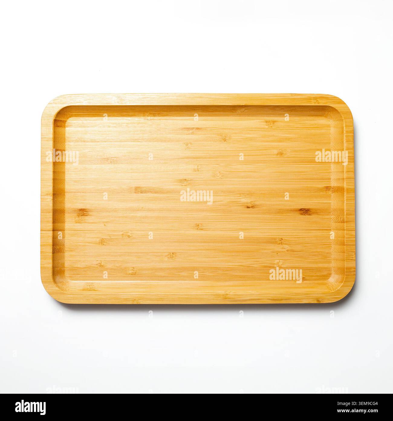 A rectangular eco-friendly bamboo tray captured from a flat lay overhead perspective on a clean white studio setup Stock Photo
