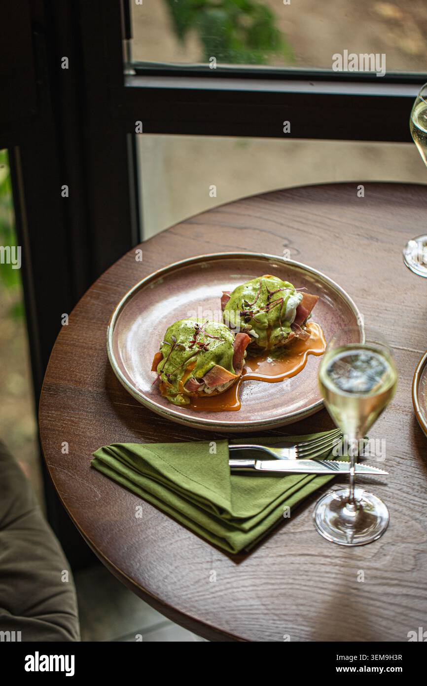 Eggs benedict brunch served with sparkling wine Stock Photo