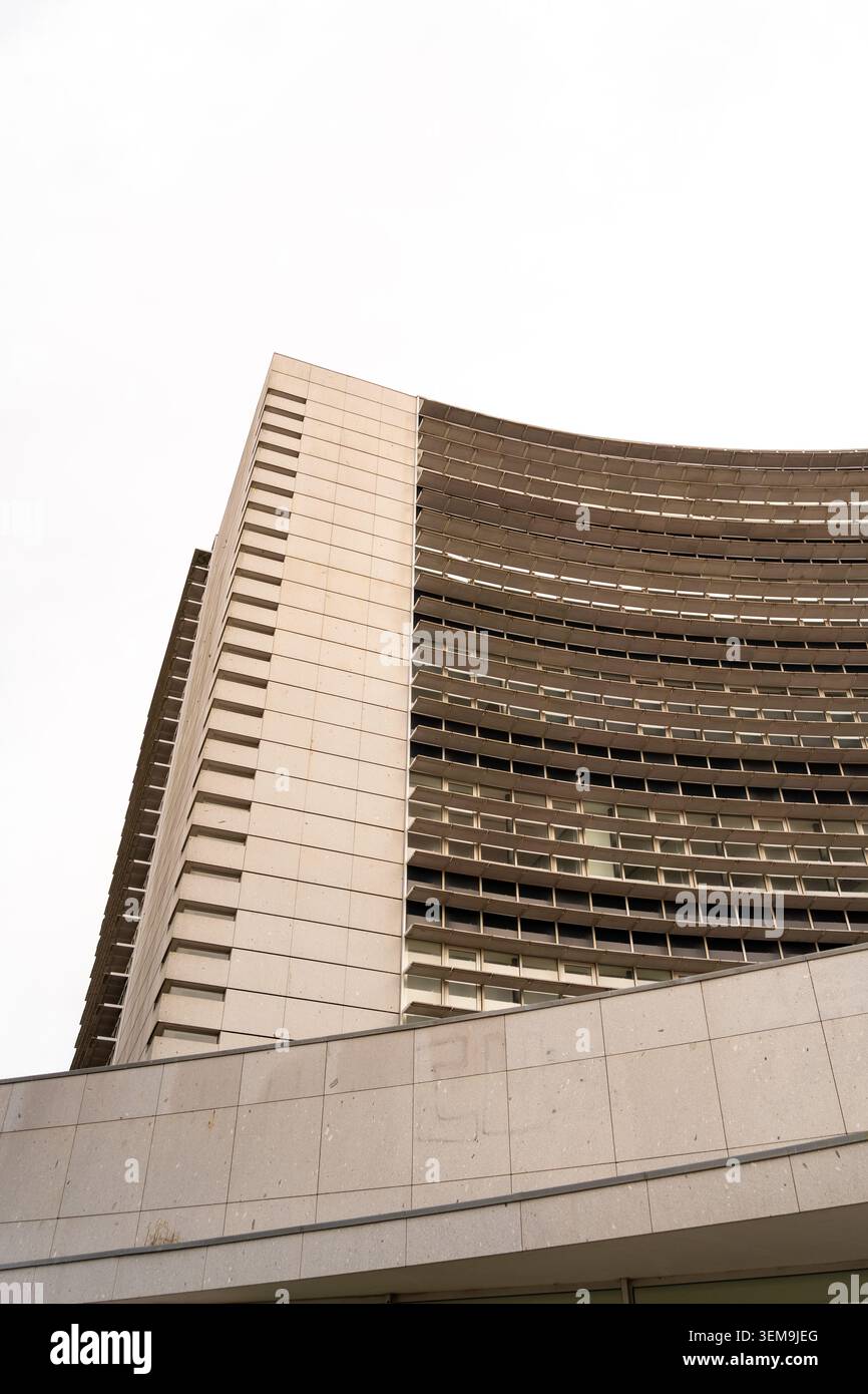Modern brutalist architecture featuring concrete surfaces, curved forms, and repetitive window patterns Stock Photo
