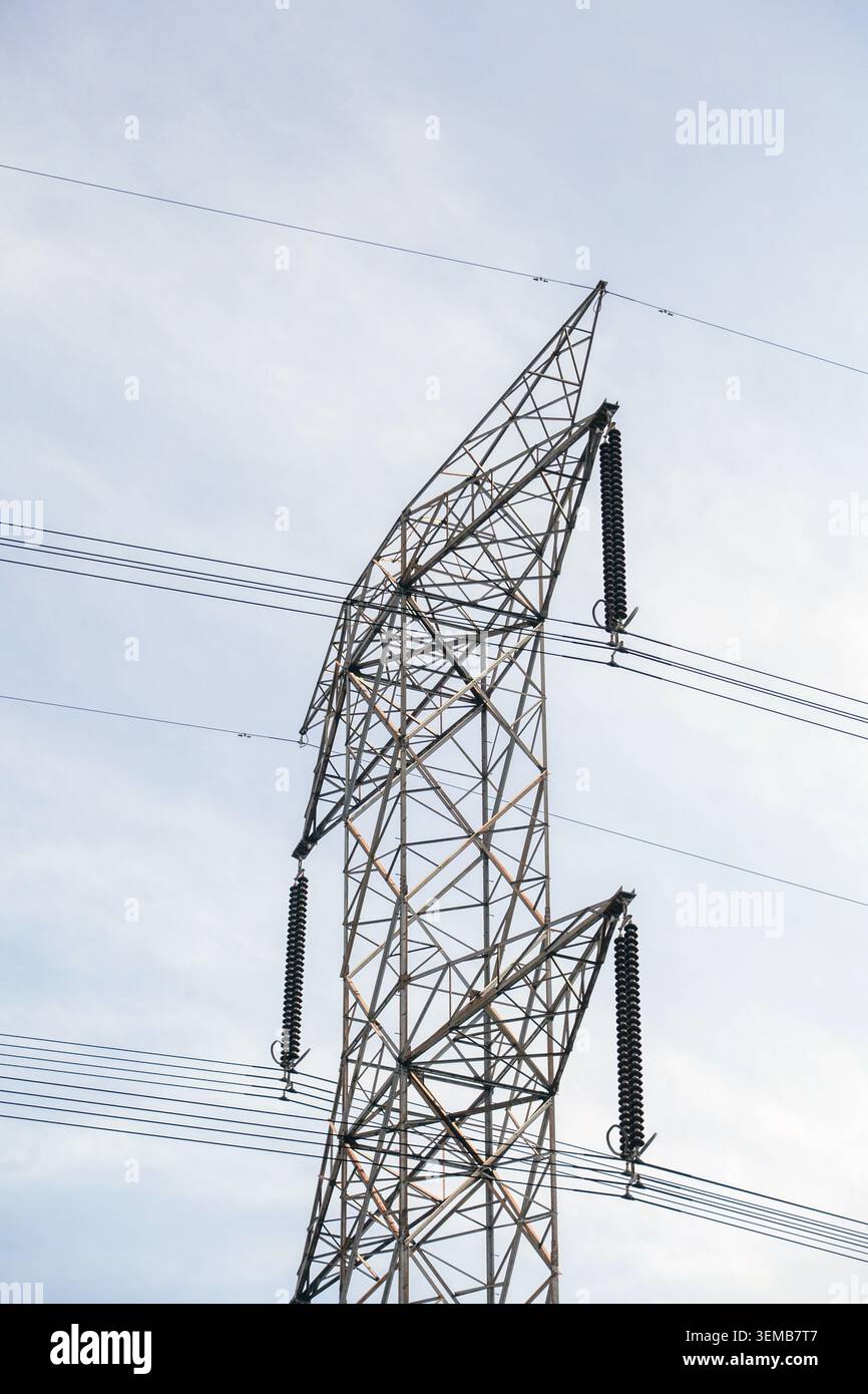 High Voltage Power Line Tower on sky background Stock Photo