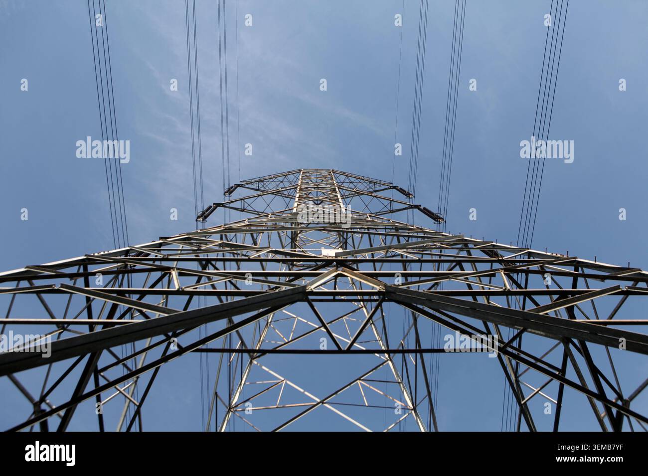 High Voltage Power Line Tower on sky background Stock Photo
