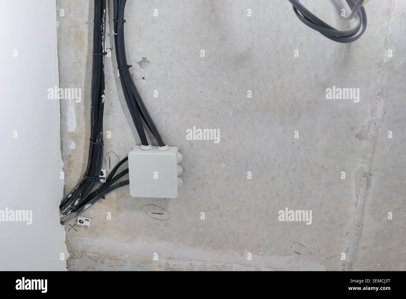 Electrical junction box and wires on concrete ceiling Stock Photo