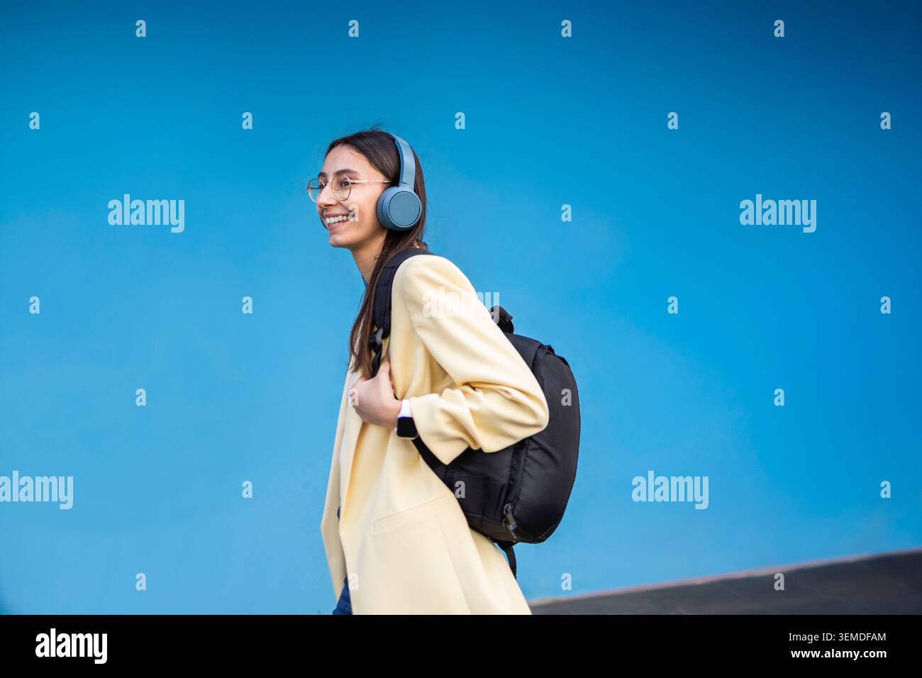 Side profile of a woman wearing headphones hi-res stock