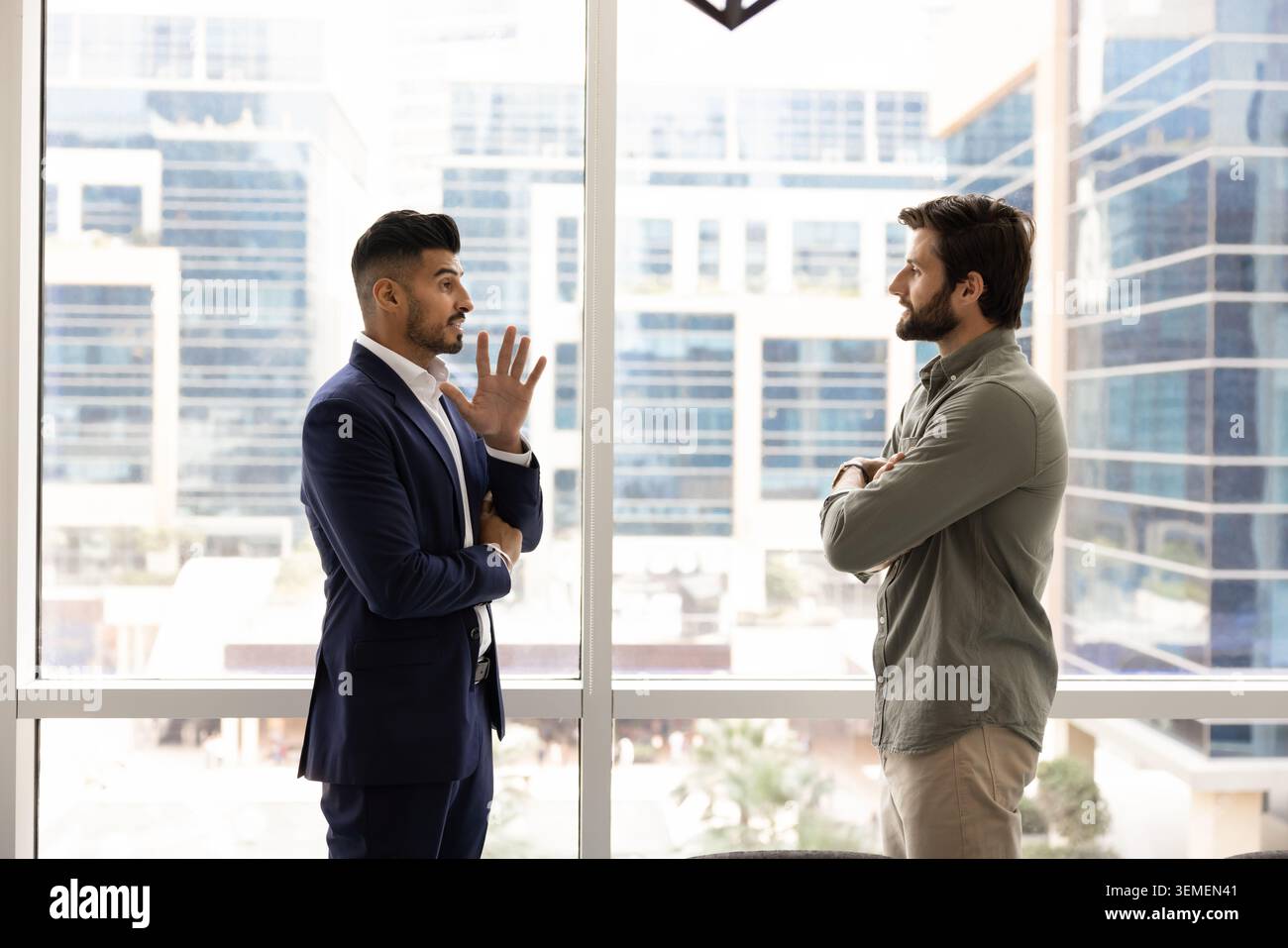 Two businessmen exchanging ideas in modern office Stock Photo