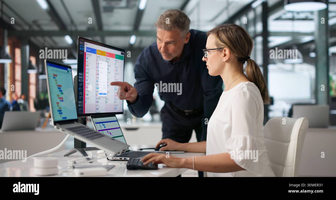 An Agile Manager Guides Team Members Using Scrum Board For Task Planning. Stock Photo