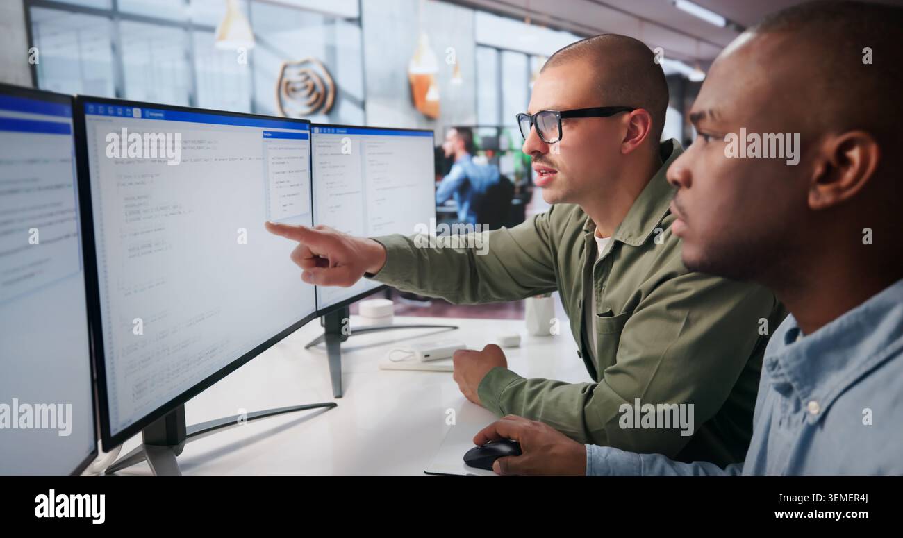Two Young Software Engineers Work Together Coding Secure Web Applications. Stock Photo