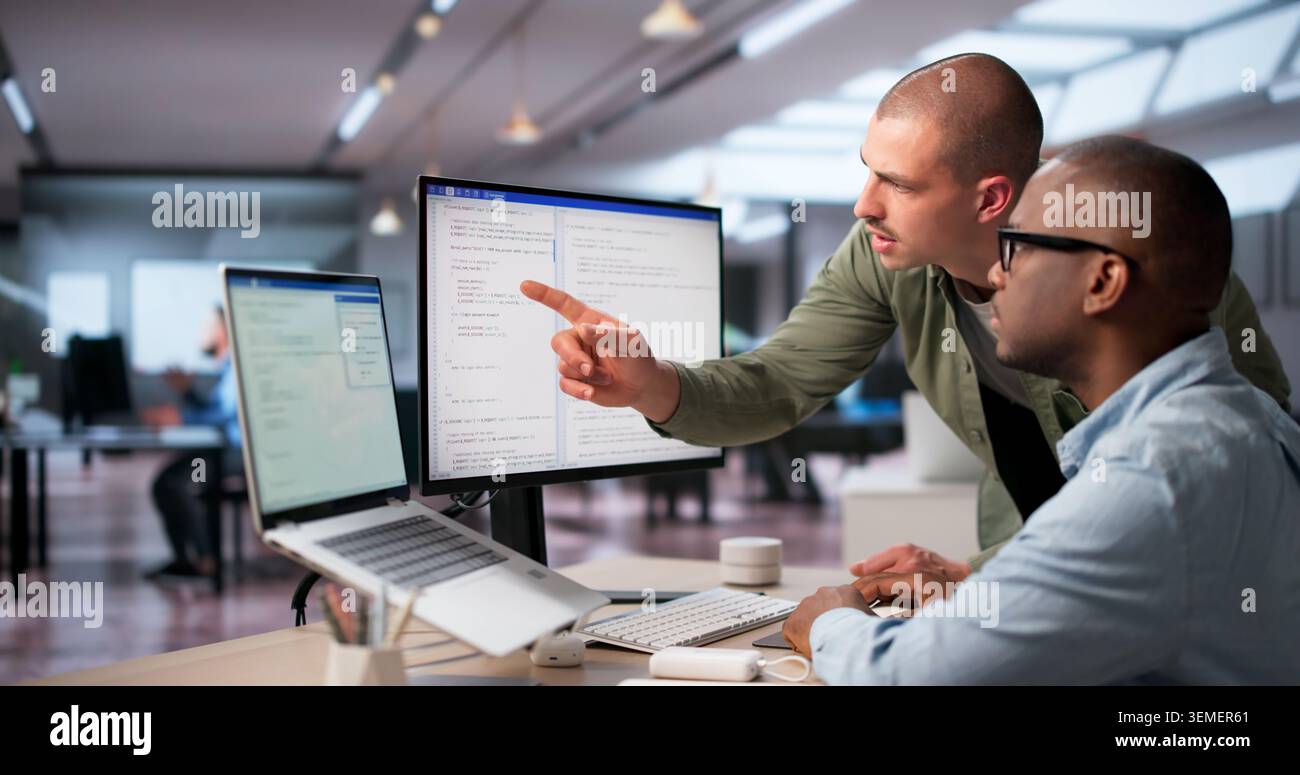 Software Engineers Work Together In Office Coding Secure Web Systems. Stock Photo