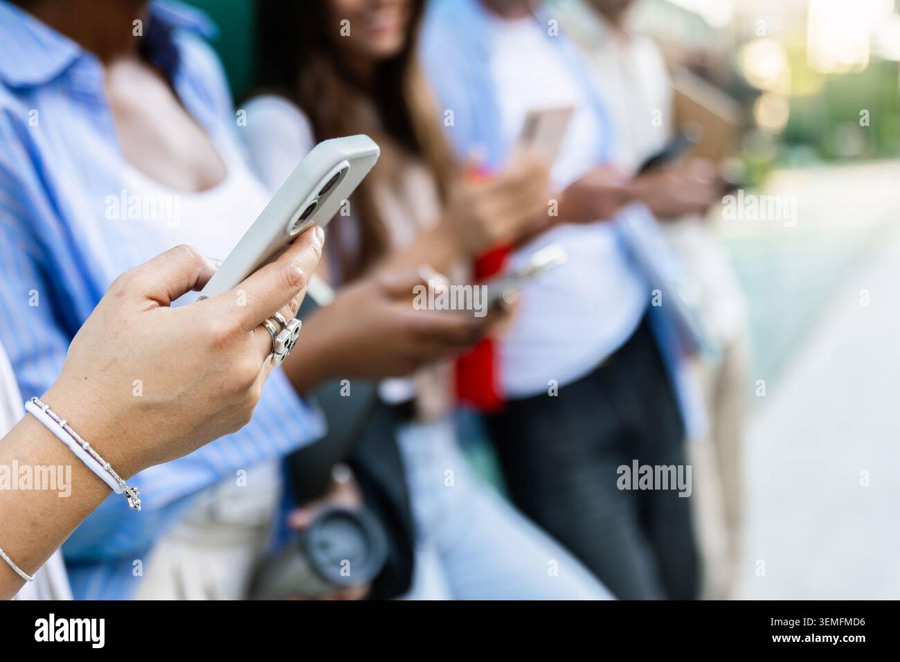 Diverse students using smart phones while spending time together Stock Photo