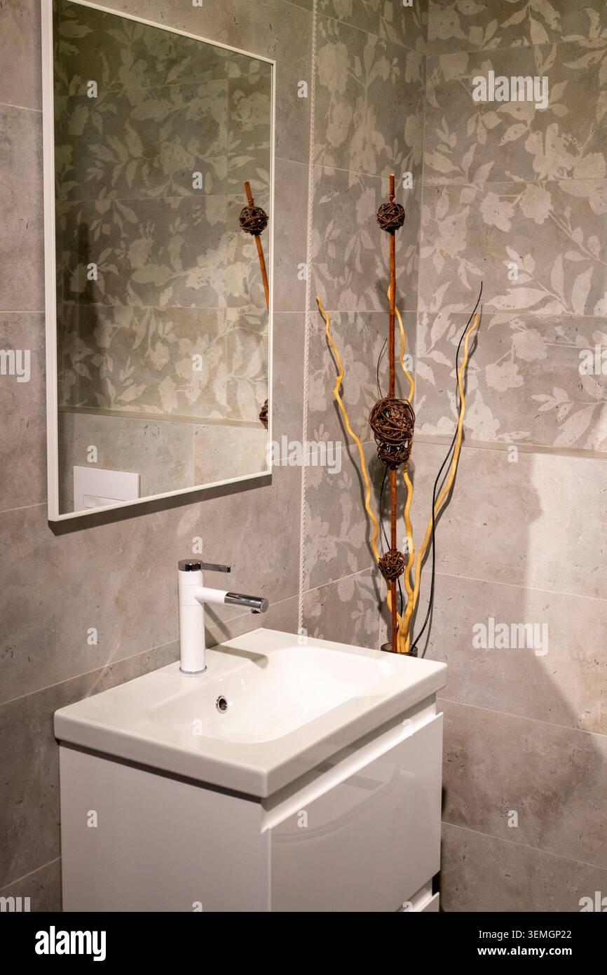 Modern Grey Bathroom Interior with Floating Vanity and Patterned Tiles Stock Photo