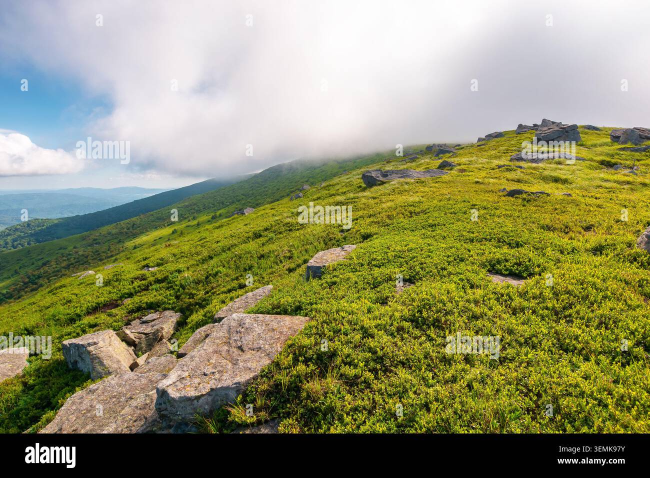 nature scenery with mountain under summer sky. alpine landscape of carpathian mountain with grassy slopes. low fluffy clouds on high altitude. summer Stock Photo