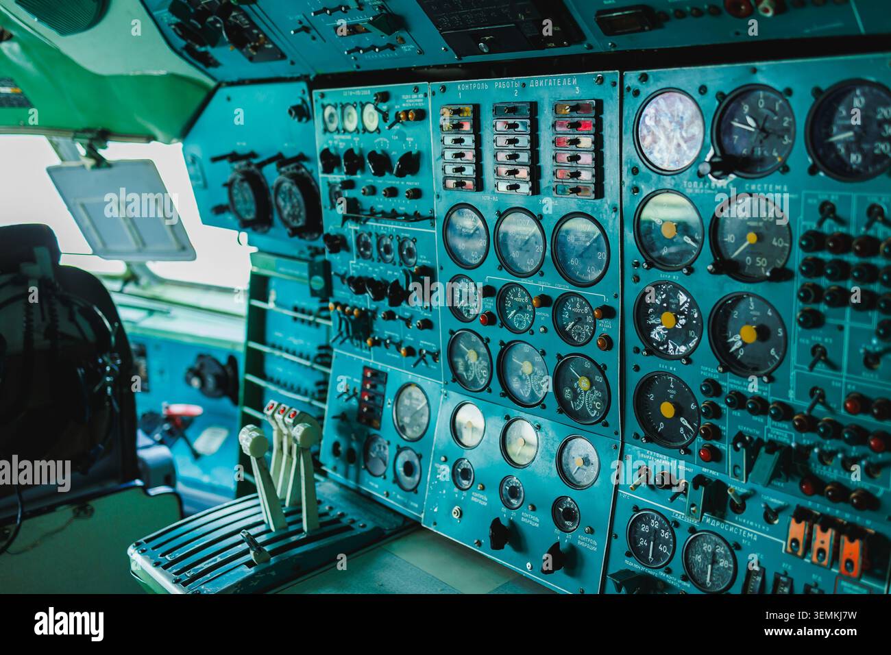 Inside an aircraft cockpit, the control panel displays multiple dials ...