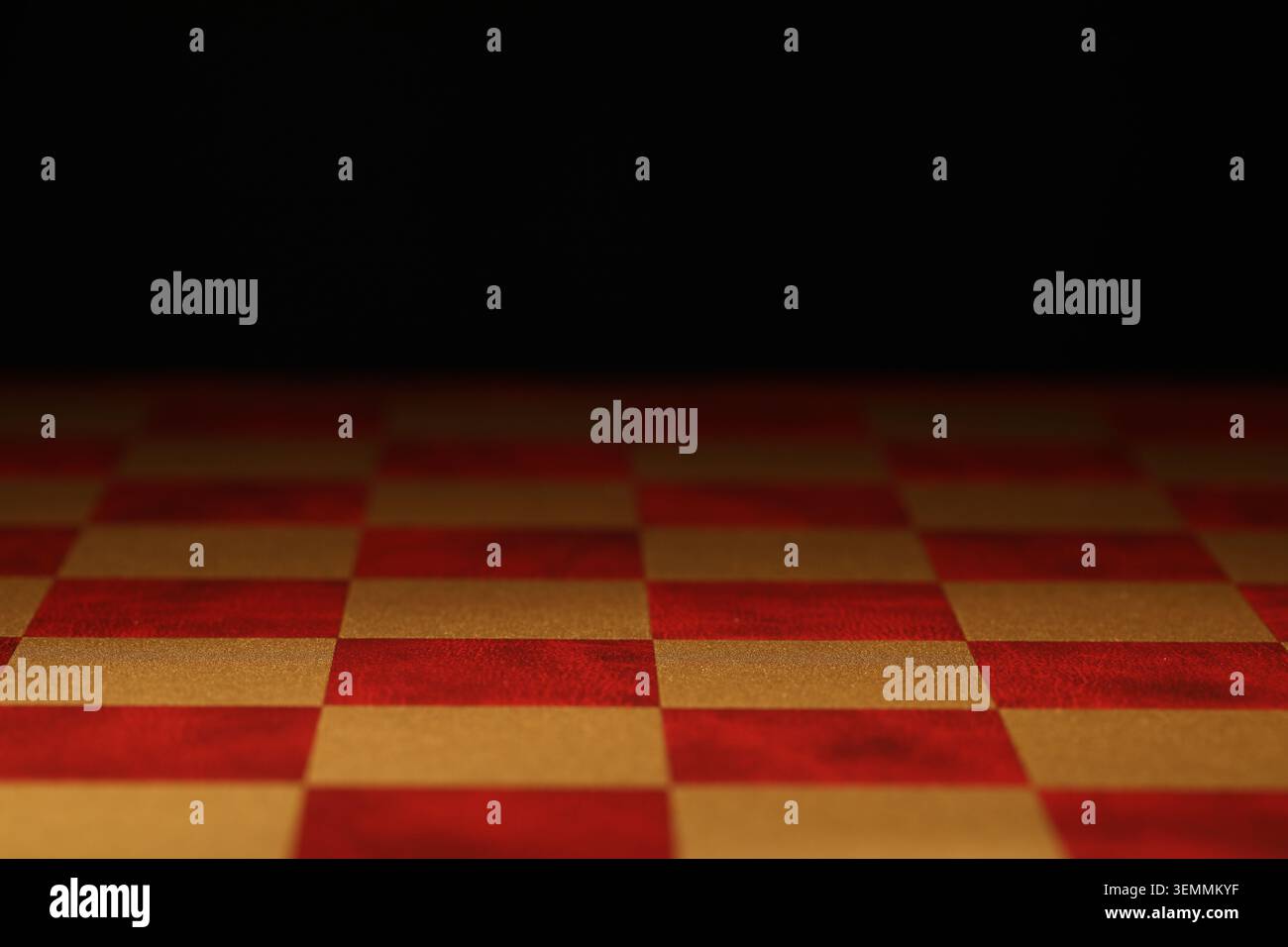 Checkered chessboard on dark background, closeup view Stock Photo