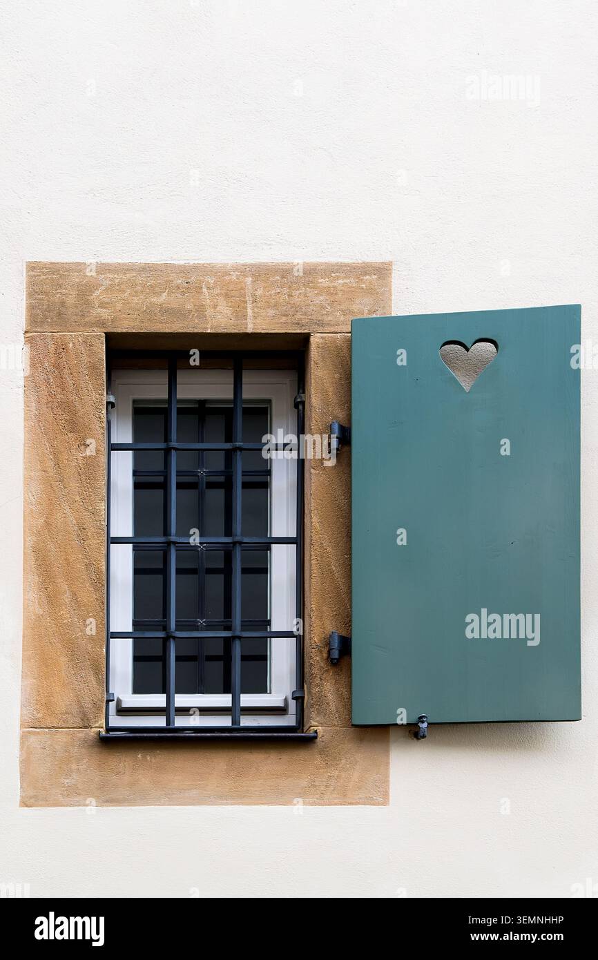 Plastic window with lattice and open shutter Stock Photo