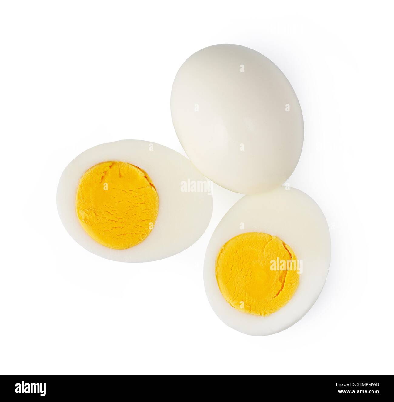 Hard-boiled chicken eggs showing one whole and two halves with visible yolk and white Stock Photo