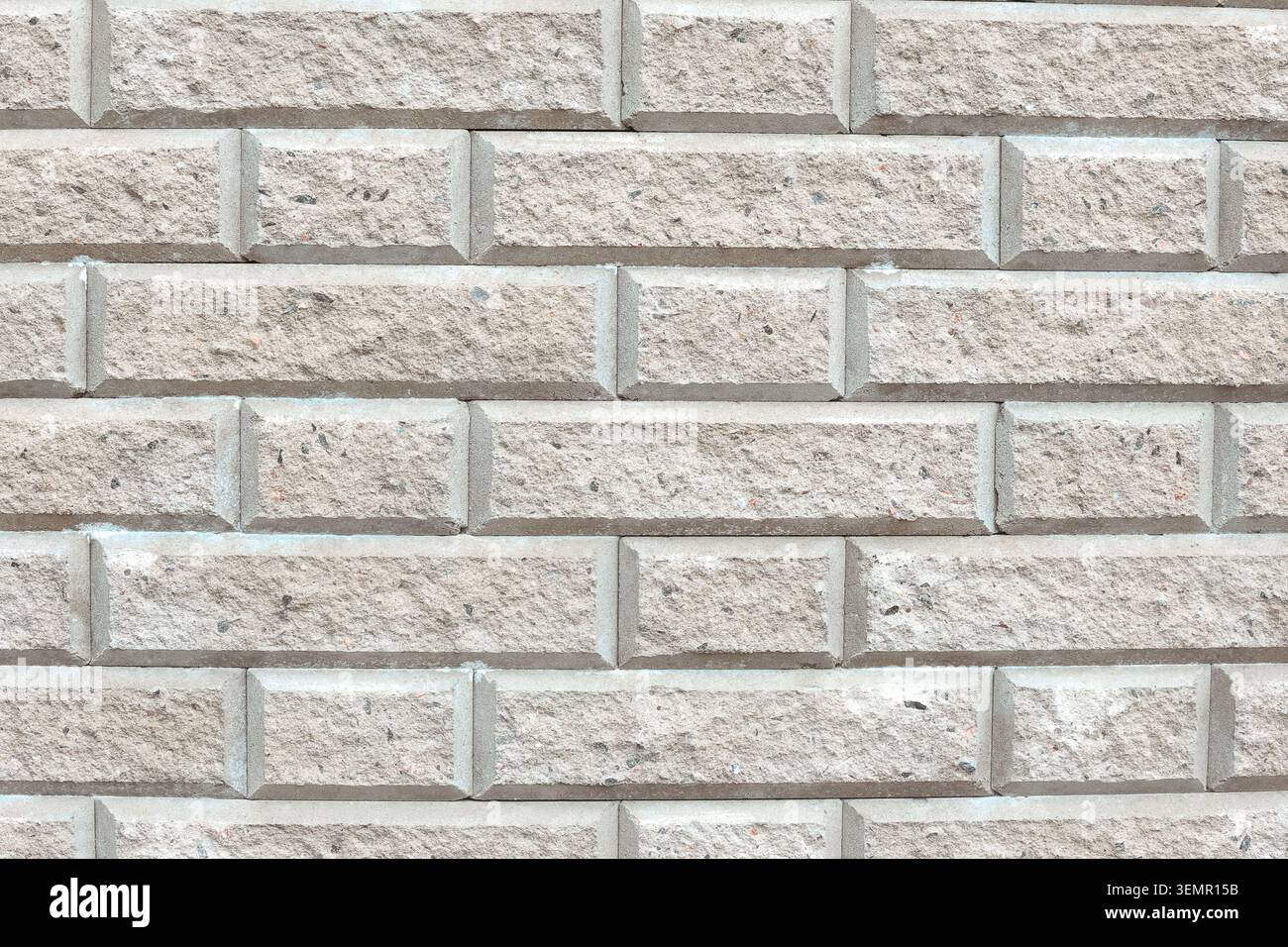 Weathered light gray stone wall texture with rectangular blocks and cracks Stock Photo