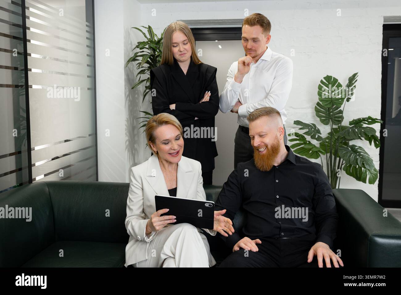 Business team discussing project strategy using digital tablet in office Stock Photo