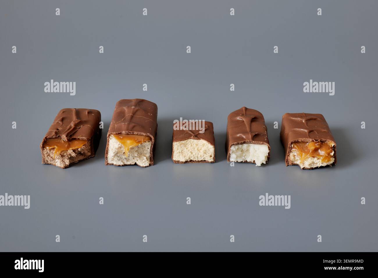 Five chocolate bars with assorted fillings on a gray background Stock Photo