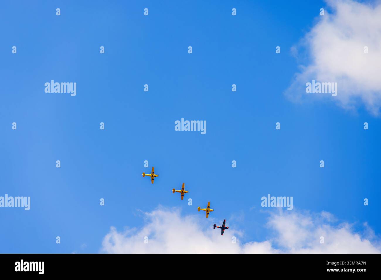 Propeller planes flying in formation on a blue sky Stock Photo