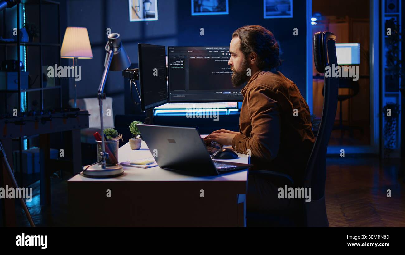 Developer pressed by deadline, drinking coffee and doing multitasking to finish developing PC code. Stock Photo