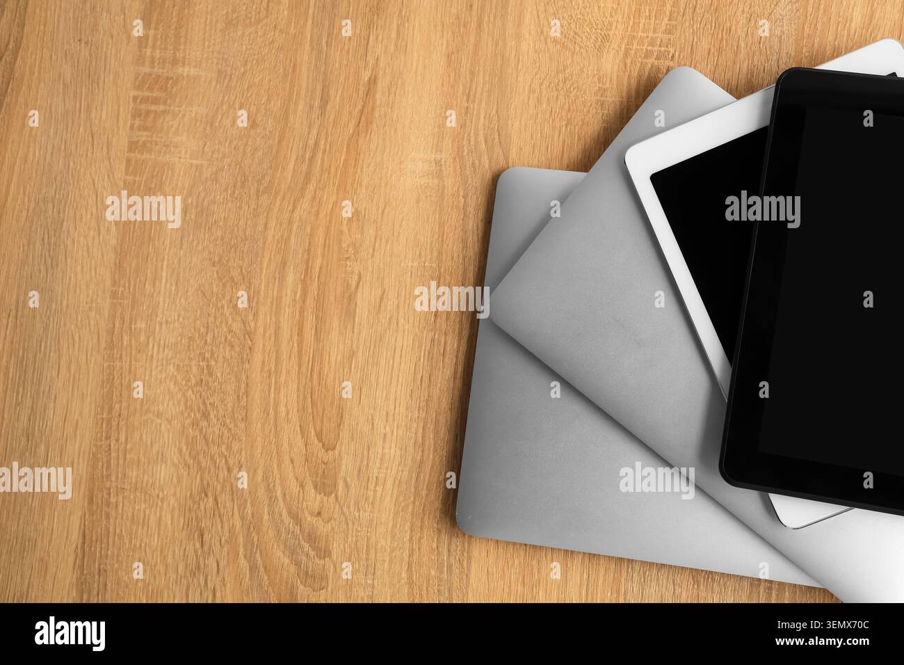 Stack of modern gadgets on wooden table Stock Photo