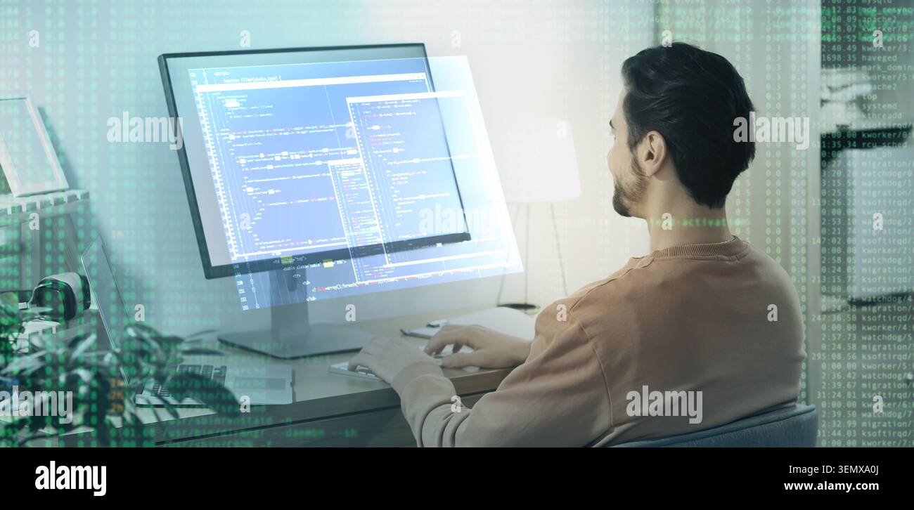 Software developer working on computer with code overlay, programming and digital technology concept, modern office environment Stock Photo