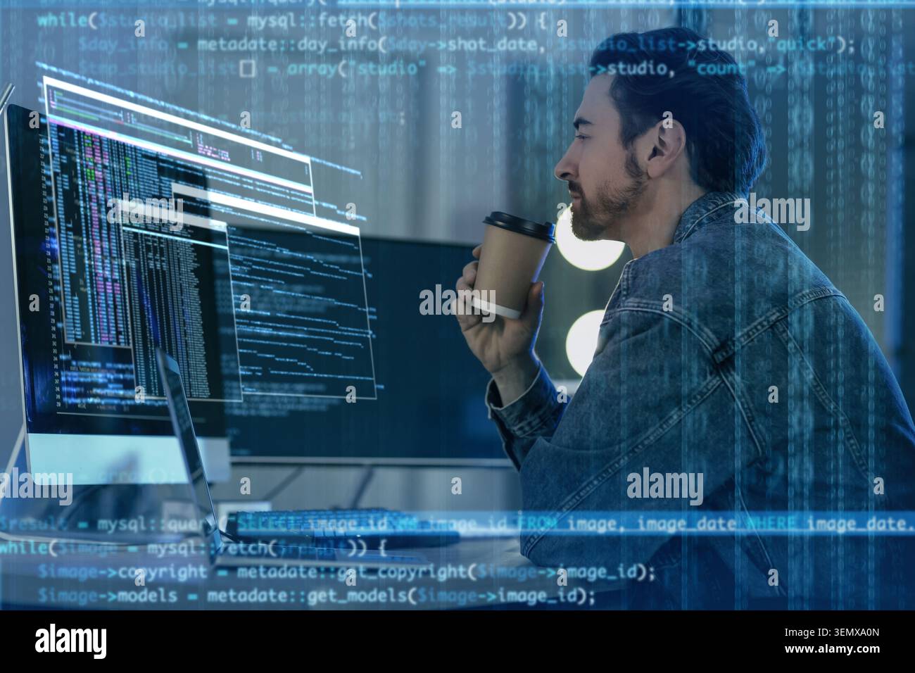 Focused male programmer drinking coffee while coding on computer, software development and data analysis Stock Photo