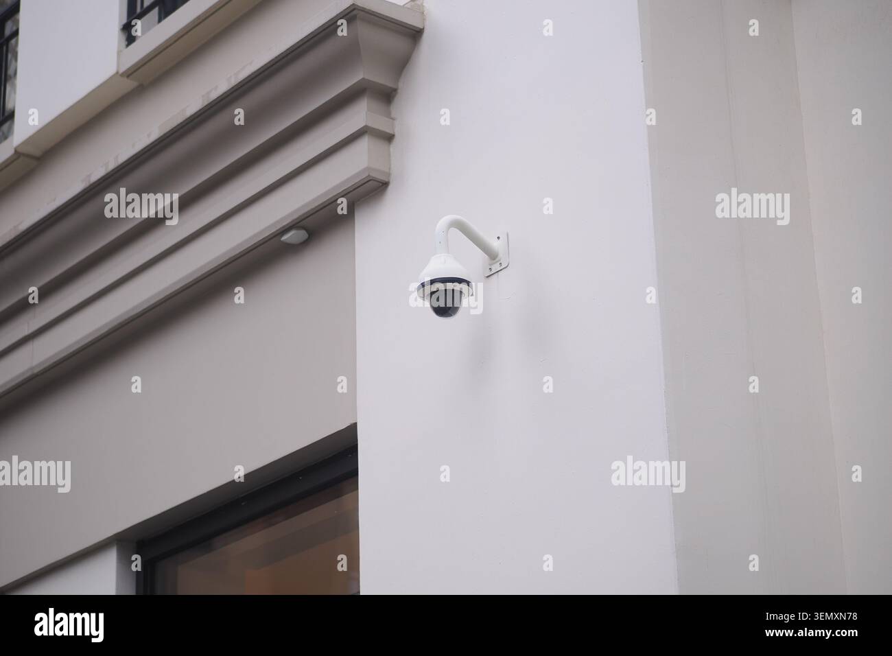 Security camera mounted on wall outside a building Stock Photo
