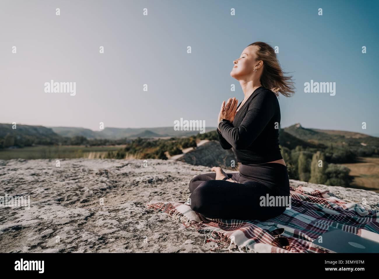 Woman Meditating on a Mountaintop Stock Photo