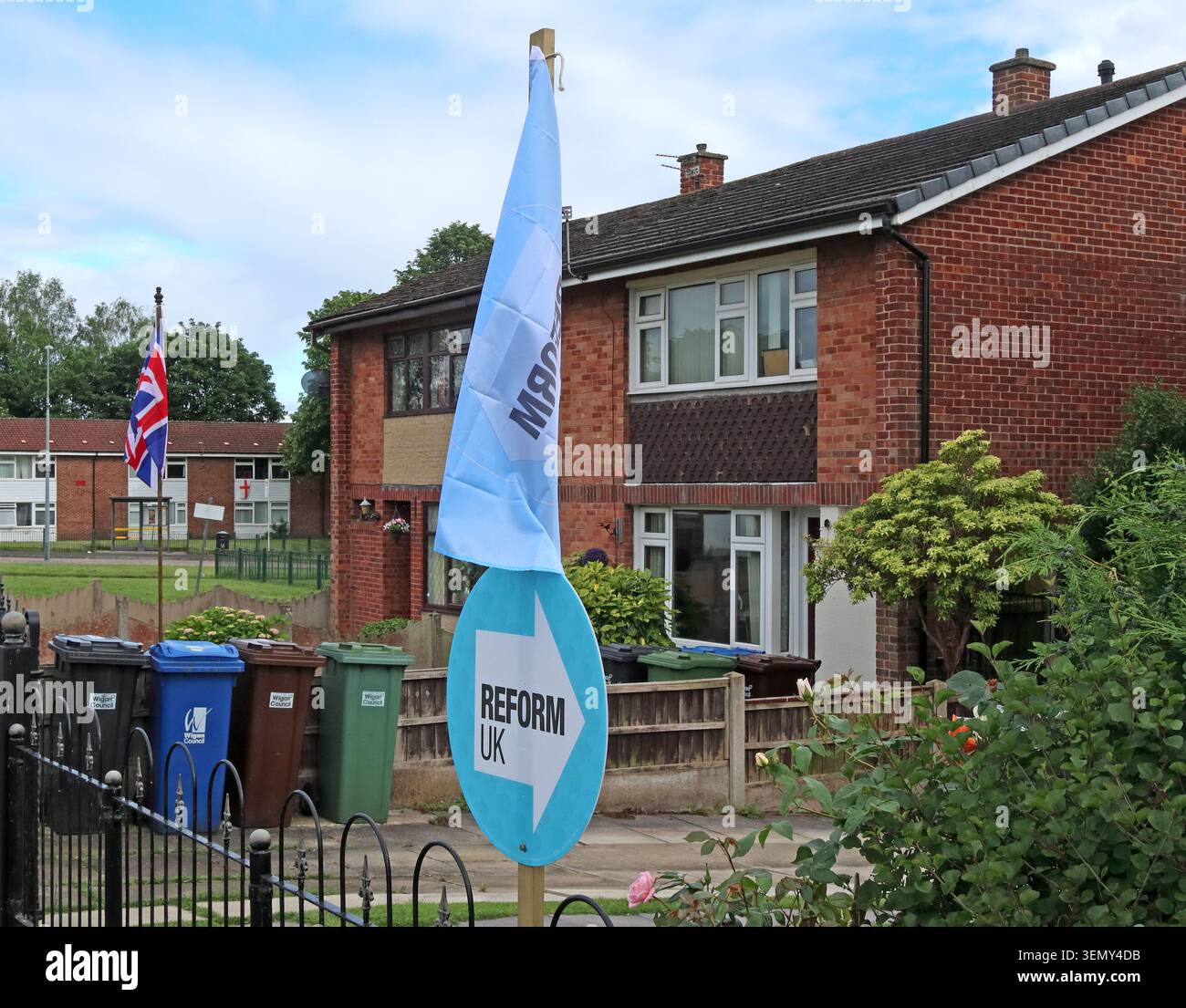 Fan of ReformUK Rob Kenyon on Norfolk Close, Hindley, Wigan WN2 4JS, rocking it with a Union Jack, Reform flag and a blue roundel Stock Photo