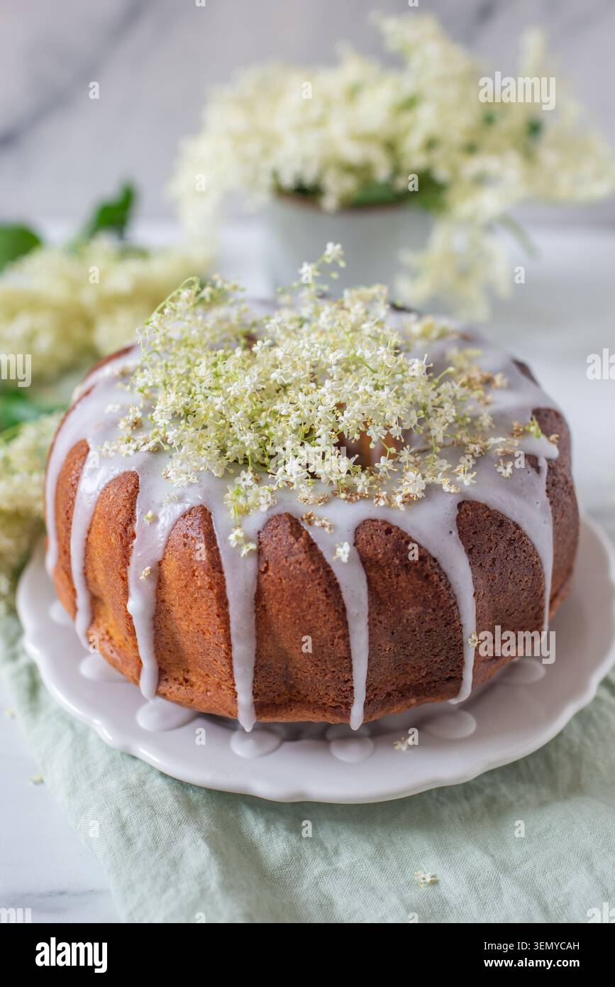 home made elderflower bundt cake with raspberries Stock Photo