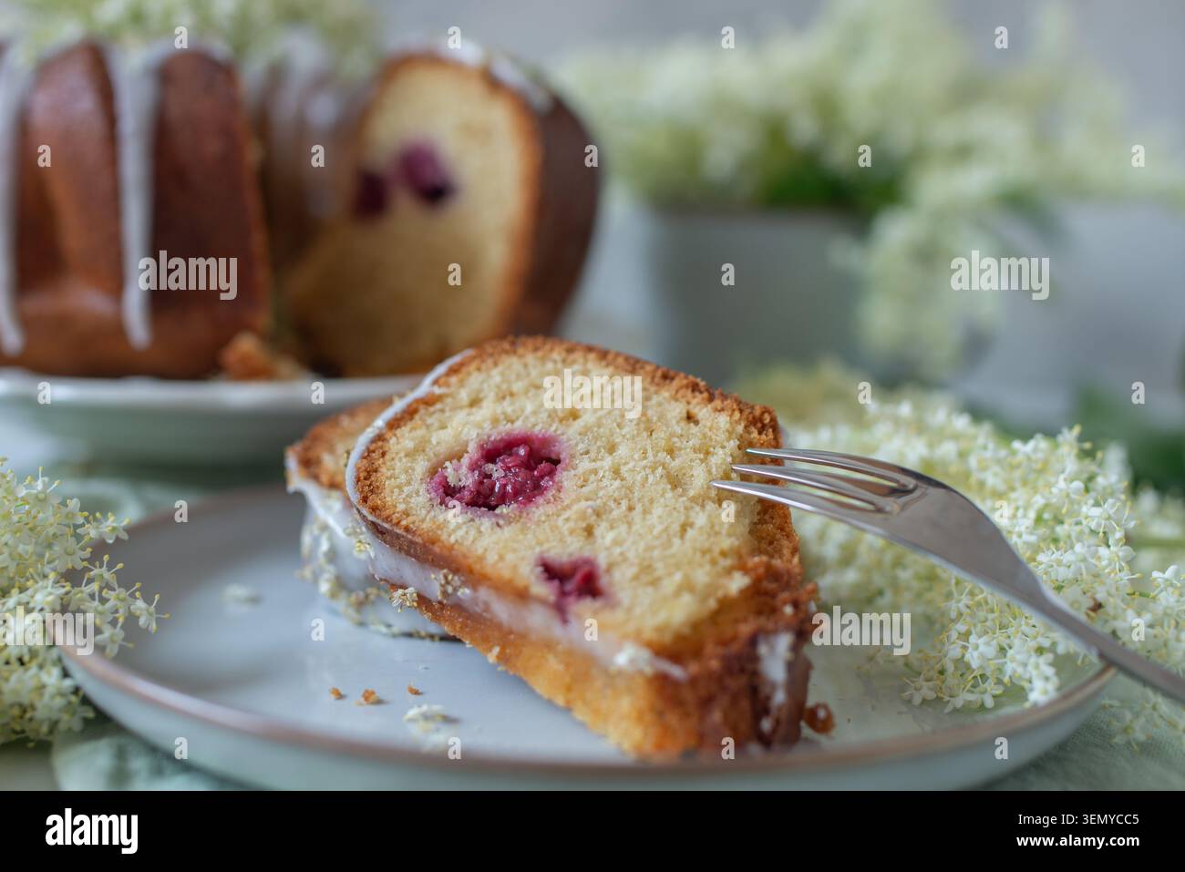 home made elderflower bundt cake with raspberries Stock Photo