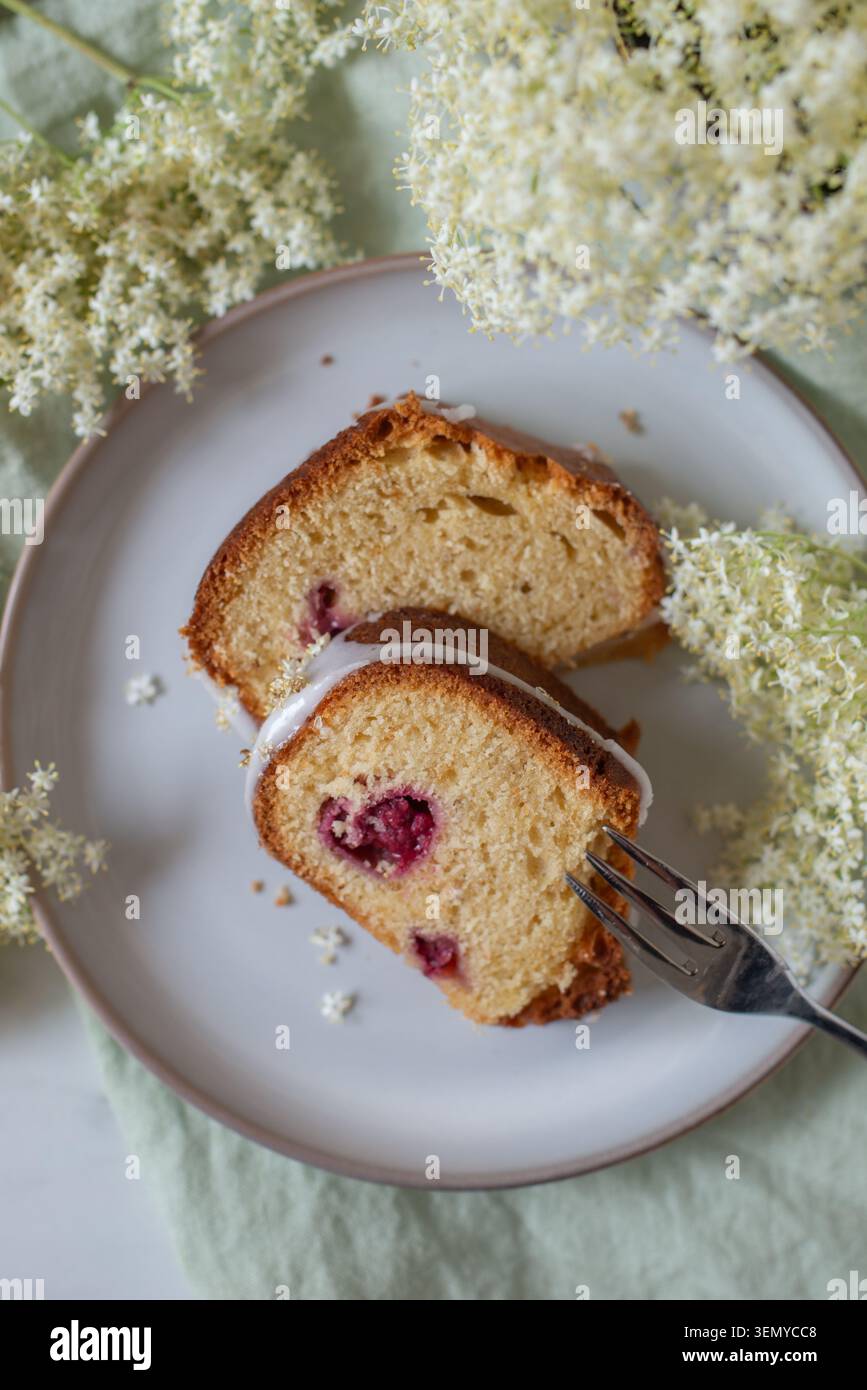 home made elderflower bundt cake with raspberries Stock Photo