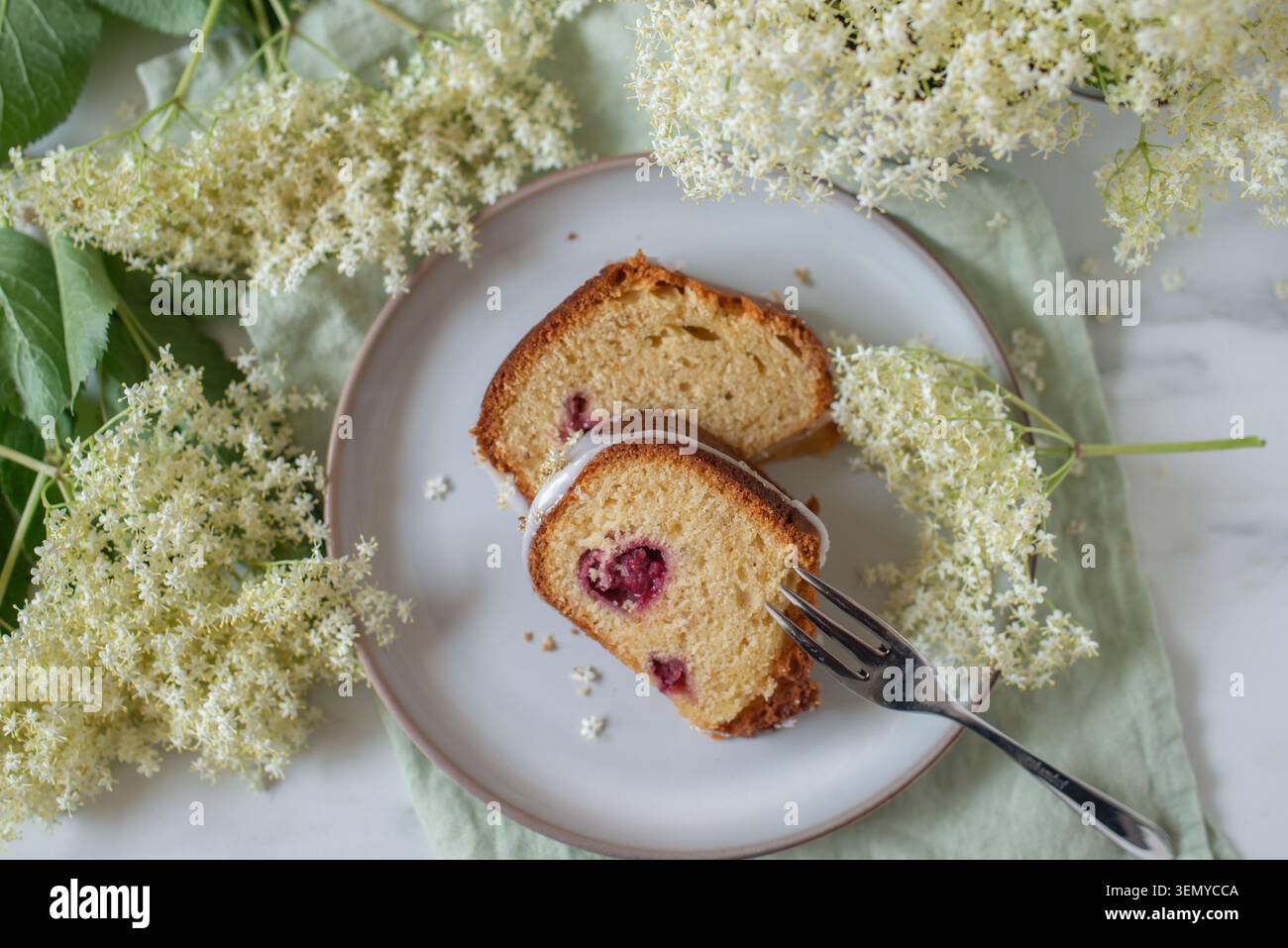 home made elderflower bundt cake with raspberries Stock Photo