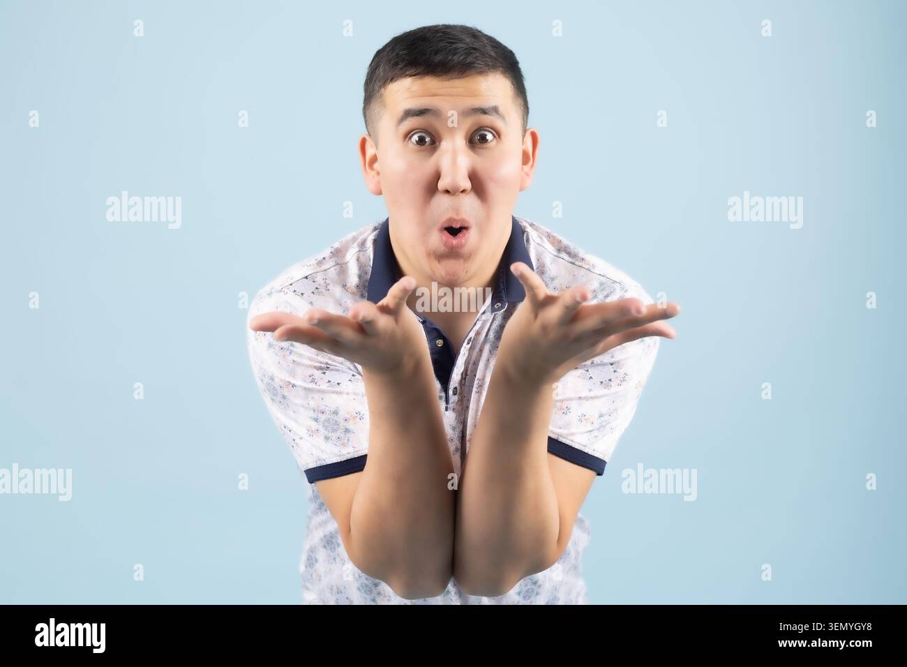 Handsome young expressive man posing emotionally in professional studio Stock Photo