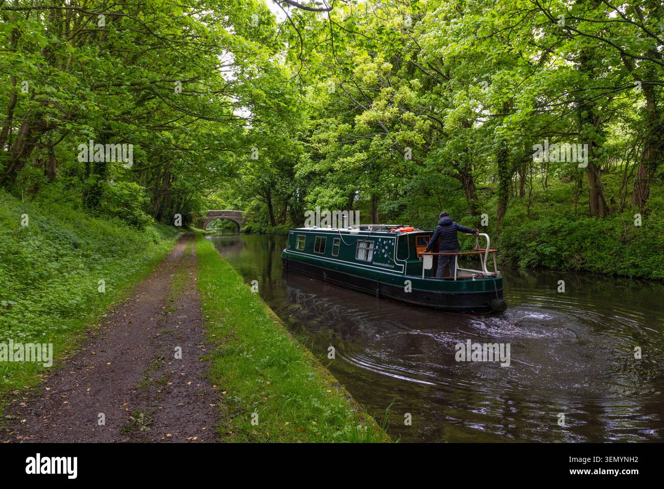 Tranquil waters and moored narrowboats on the historic Lancaster Canal at Galgate in Lancashire, North West England. Stock Photo