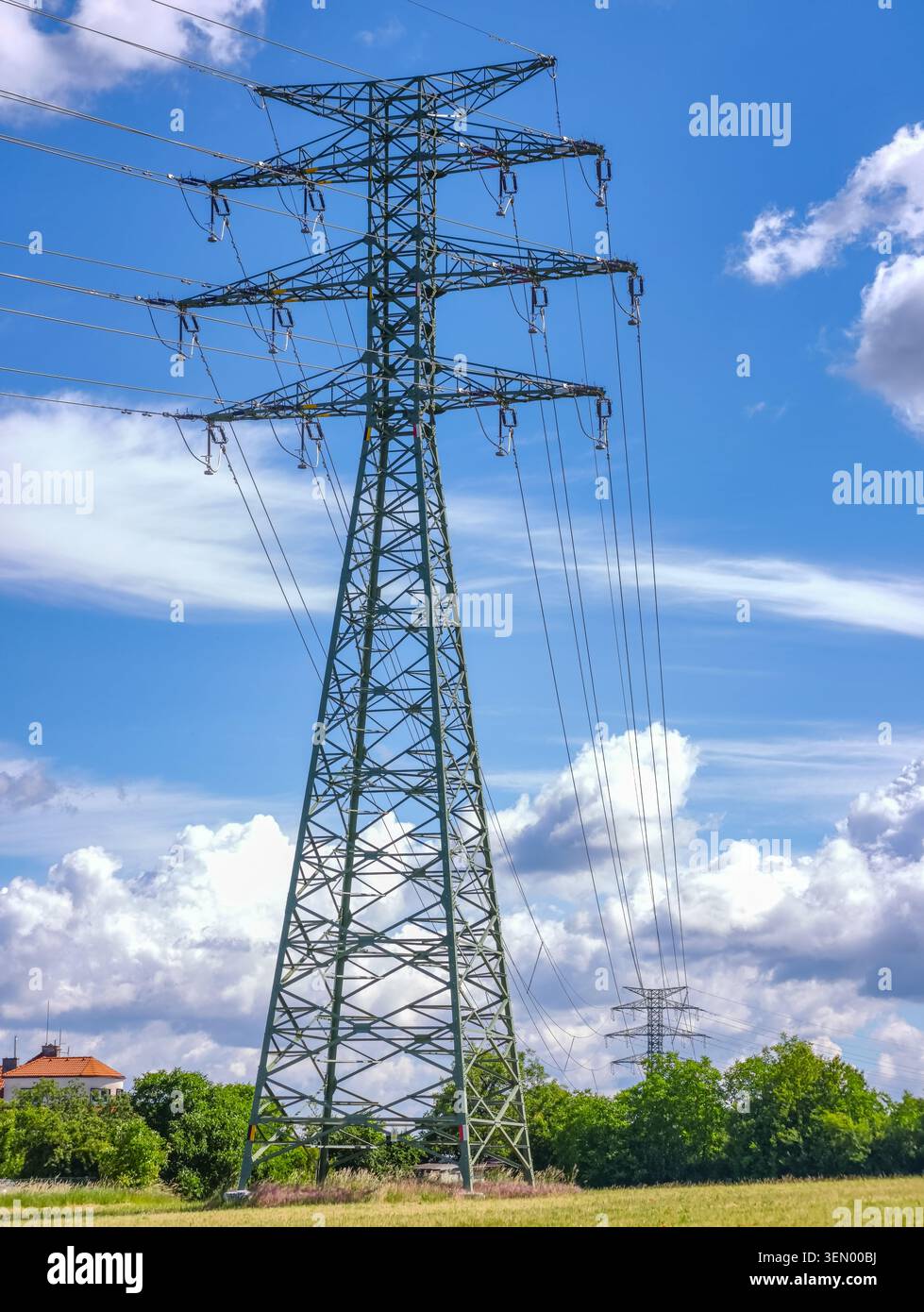 High-voltage electrical transmission tower with power lines in an open ...