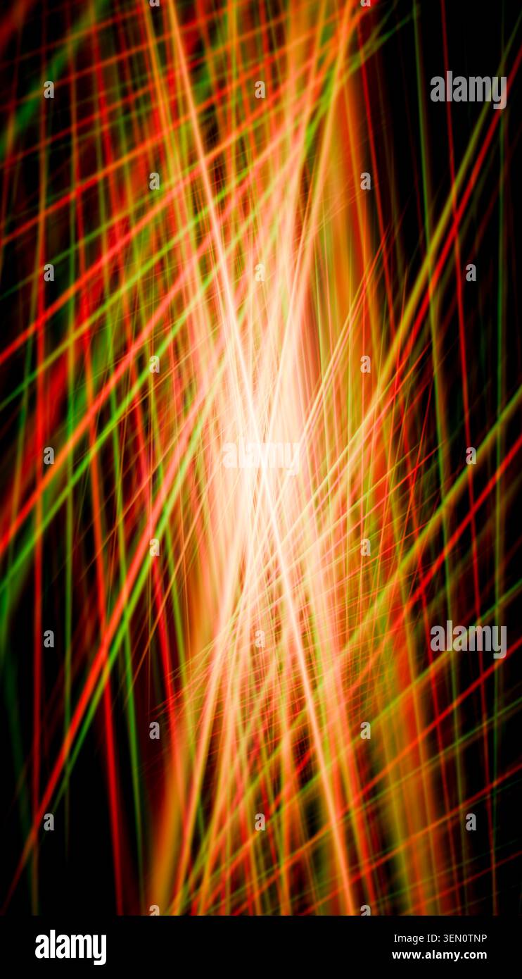 Bright intersecting red and green light trails creating a dynamic abstract pattern. Stock Photo