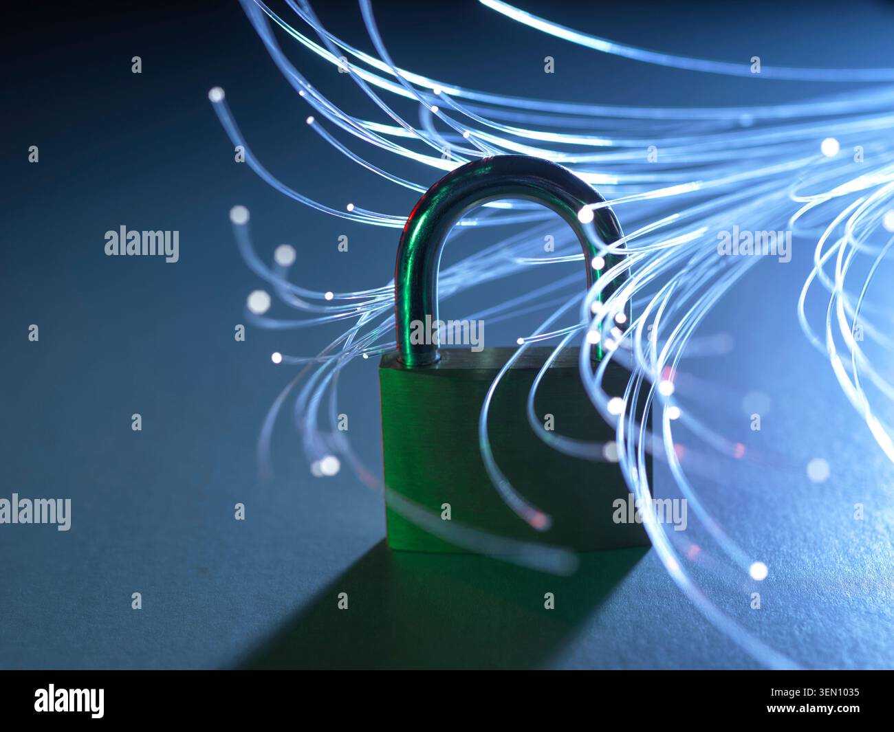 Padlock with glowing fiber optic strands representing data security and internet. Stock Photo