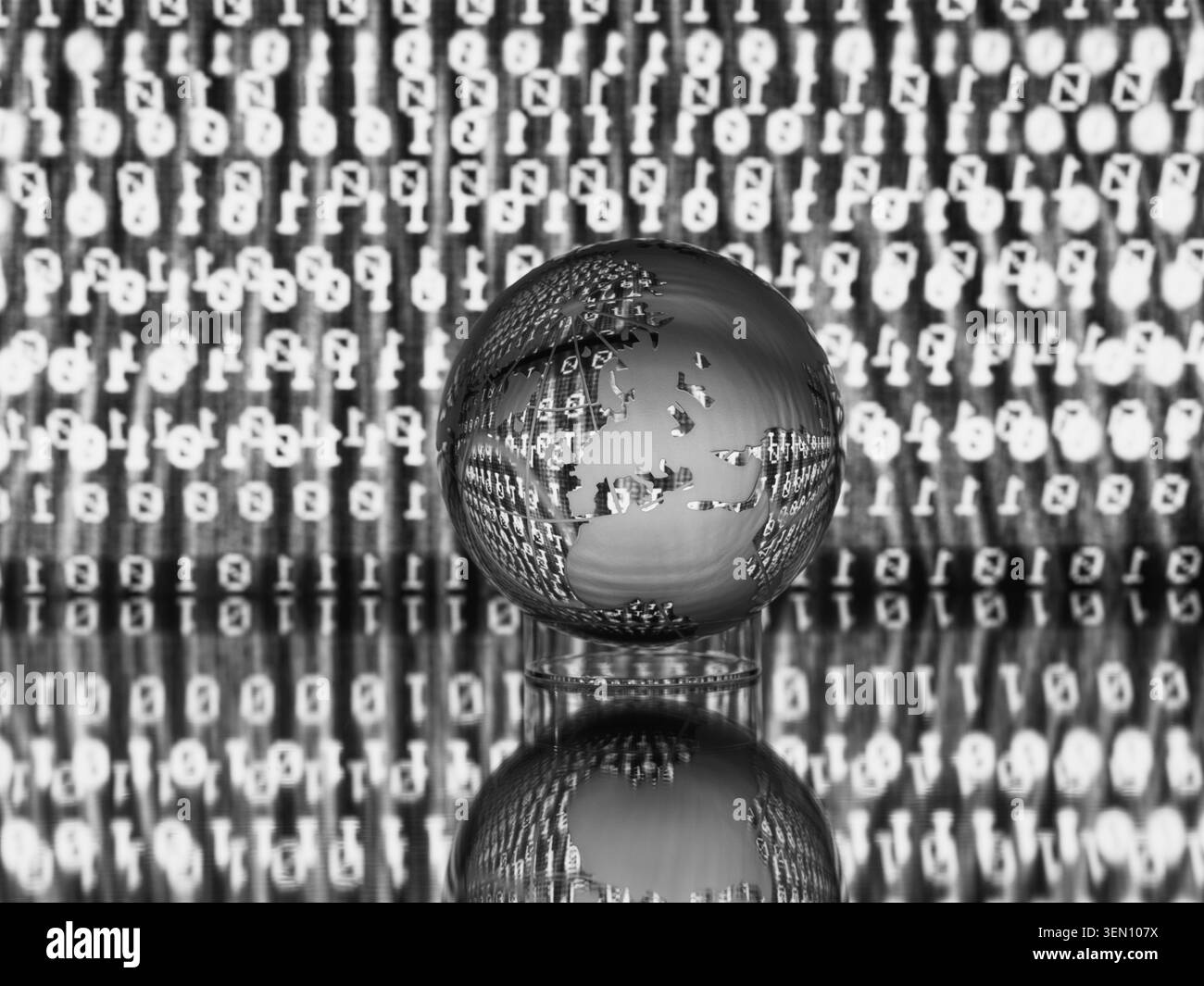 Glass globe with etched continents reflecting on binary code background in black and white. Stock Photo